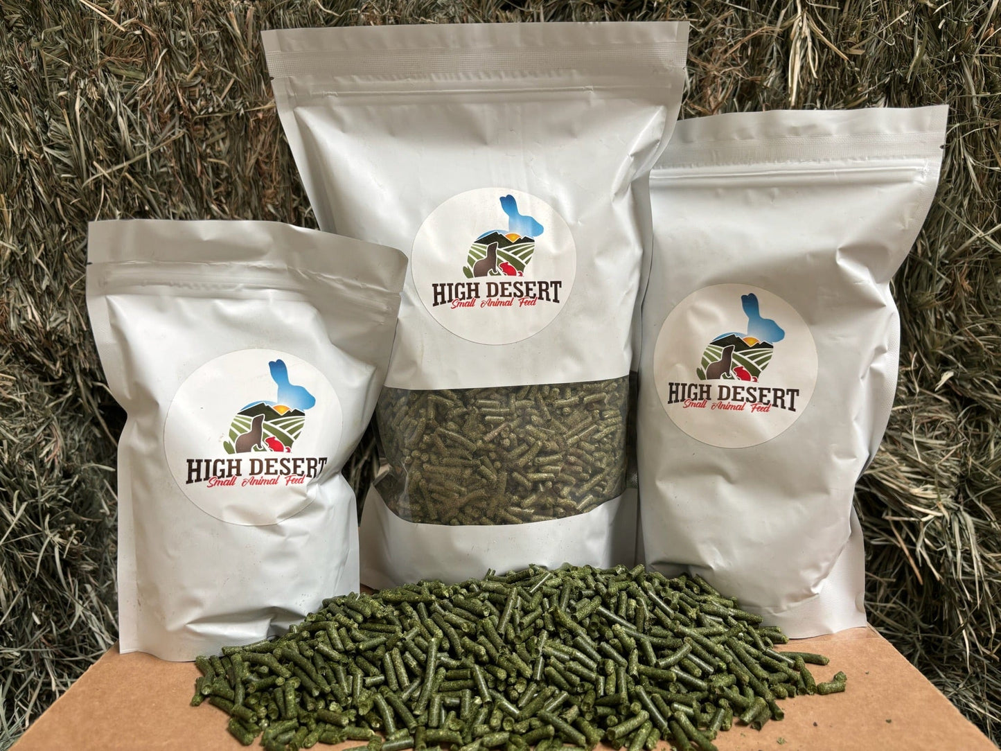 Three bags of rabbit food with a pile of pellets.