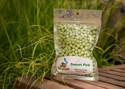 Packaged freeze-dried sweet peas on a wooden surface with grass in the background